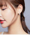 Boucle d'oreille en forme de trèfle