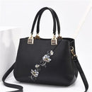 Sac à main fleuri noir